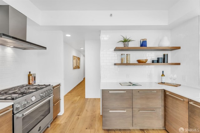 425 1st St Unit 1902, San Francisco, CA 94105 - kitchen featuring high end stainless steel range oven, wall chimney range hood, modern cabinets, light countertops, and light wood-style floors