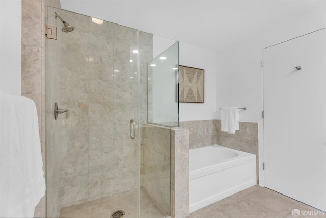 425 1st St Unit 1902, San Francisco, CA 94105 - bathroom featuring a bath, a stall shower, and tile patterned flooring