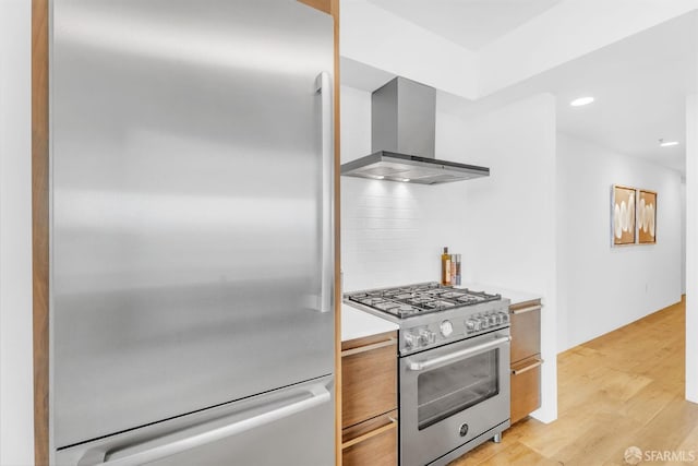 425 1st St Unit 1902, San Francisco, CA 94105 - kitchen with premium appliances, wall chimney exhaust hood, light countertops, light wood finished floors, and modern cabinets