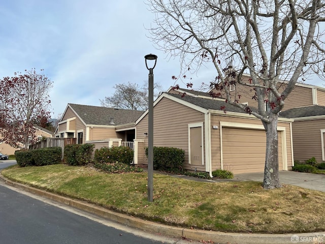 view of side of home with a garage and a lawn