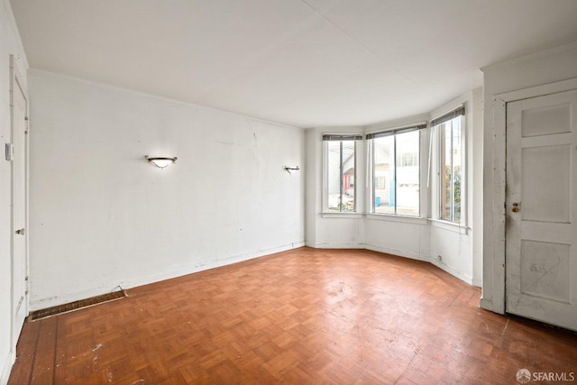 spare room featuring parquet floors