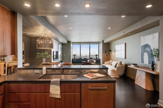 765 Market St Unit 32H, San Francisco, CA 94103 - kitchen featuring brown cabinets, a sink, open floor plan, an inviting chandelier, and recessed lighting