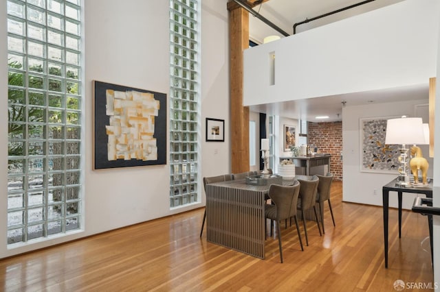 interior space featuring a high ceiling and hardwood / wood-style flooring