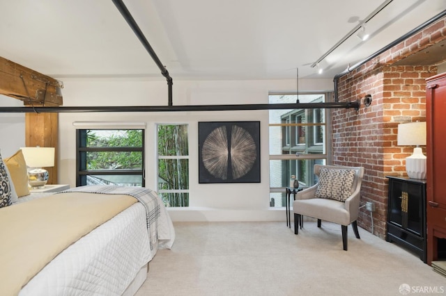 bedroom with light colored carpet and track lighting