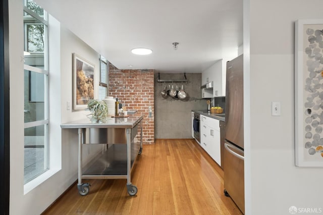 kitchen with white cabinets, stainless steel appliances, and a healthy amount of sunlight