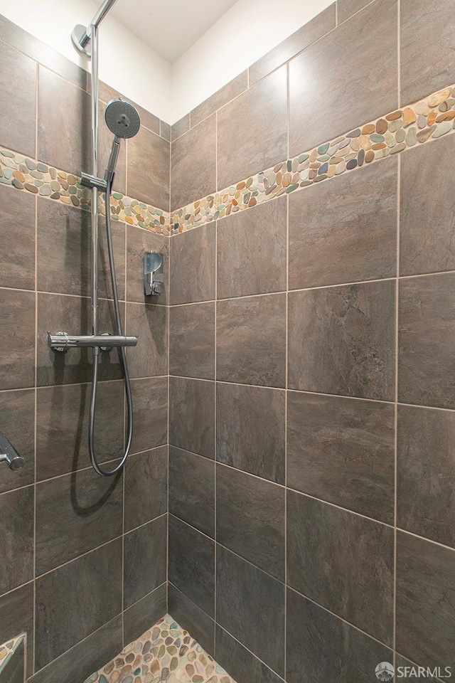 bathroom with tiled shower