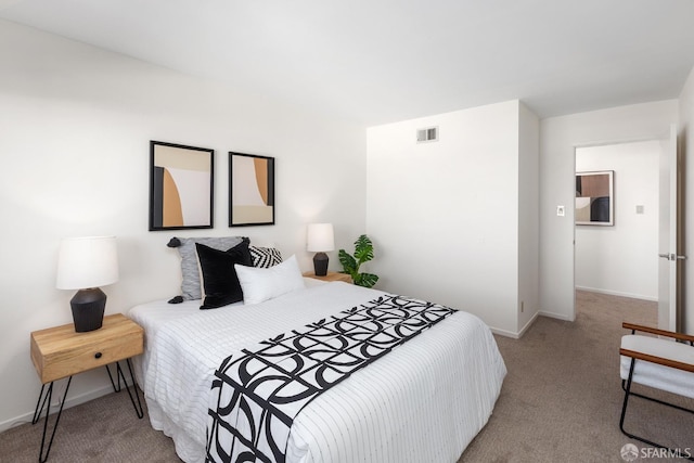 bedroom featuring light colored carpet