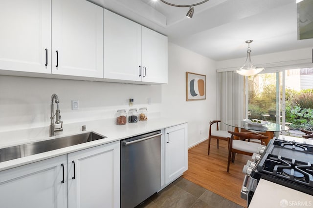 kitchen with pendant lighting, dishwasher, white cabinets, sink, and white range with gas cooktop