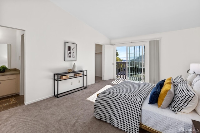 carpeted bedroom with connected bathroom, access to exterior, and vaulted ceiling