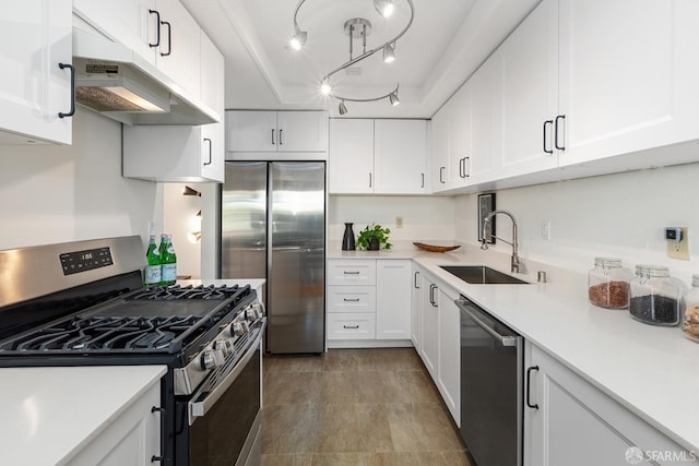 kitchen featuring appliances with stainless steel finishes, white cabinetry, and sink