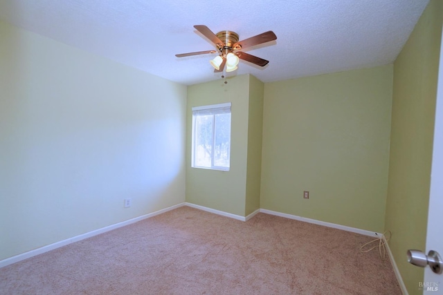 carpeted spare room featuring a textured ceiling and ceiling fan