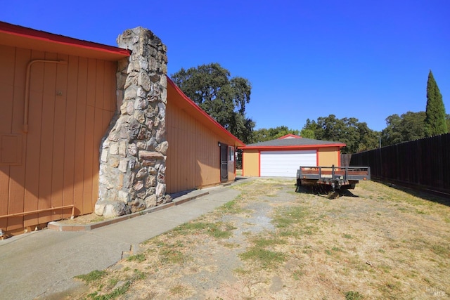 view of side of home with a yard and a garage