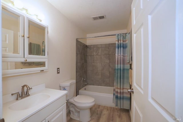 full bathroom featuring vanity, toilet, hardwood / wood-style flooring, and shower / bath combo with shower curtain