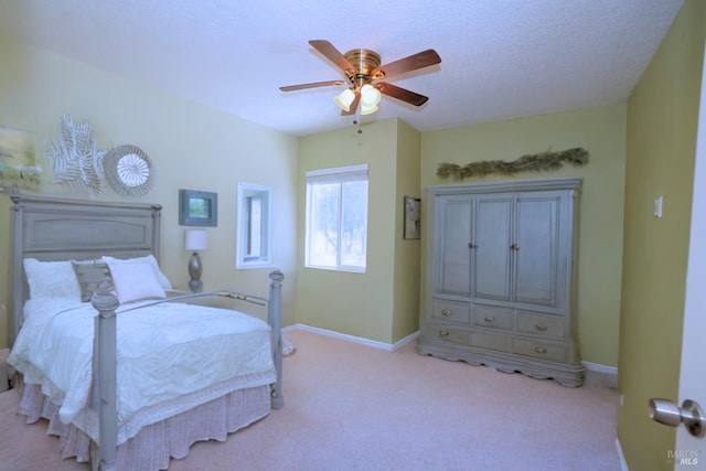 carpeted bedroom with a textured ceiling and ceiling fan