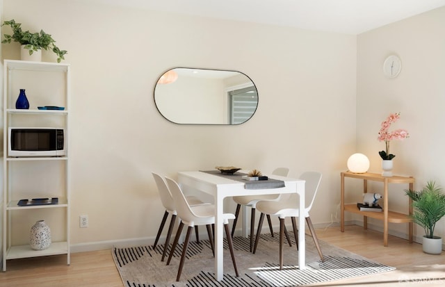 dining space with light hardwood / wood-style flooring