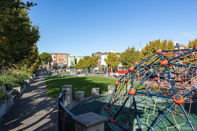 view of property's community with a lawn and a playground