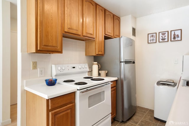 kitchen with white electric range oven and backsplash