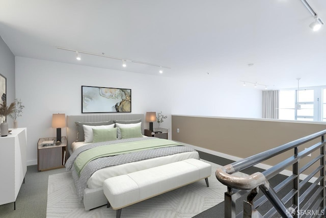 bedroom featuring rail lighting and light colored carpet