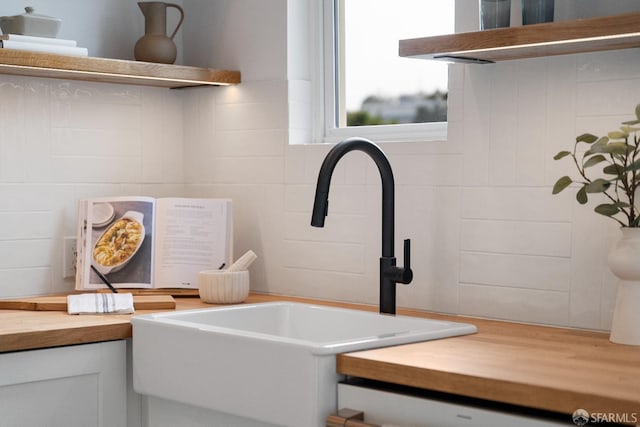 137 Edna St, San Francisco, CA 94112 - detailed view of a sink, butcher block counters, and white cabinetry