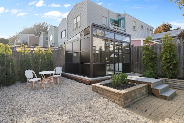 137 Edna St, San Francisco, CA 94112 - rear view of house with a sunroom, a fenced backyard, and a patio