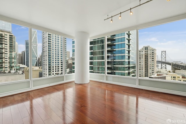 425 1st St Unit 1307, San Francisco, CA 94105 - empty room with plenty of natural light, a view of city, wood finished floors, and rail lighting