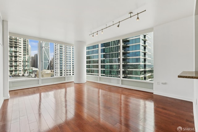 425 1st St Unit 1307, San Francisco, CA 94105 - spare room featuring wood finished floors, track lighting, a view of city, and baseboards
