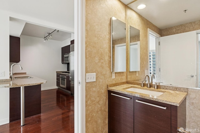 425 1st St Unit 1307, San Francisco, CA 94105 - bathroom featuring vanity, wood finished floors, rail lighting, and baseboards