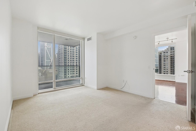 425 1st St Unit 1307, San Francisco, CA 94105 - empty room with carpet, baseboards, a view of city, and floor to ceiling windows