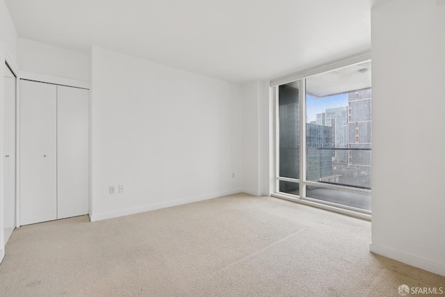 425 1st St Unit 1307, San Francisco, CA 94105 - unfurnished bedroom featuring floor to ceiling windows, carpet floors, and baseboards