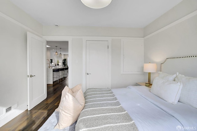 bedroom featuring dark wood-type flooring