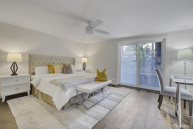 bedroom featuring access to exterior, hardwood / wood-style flooring, and ceiling fan