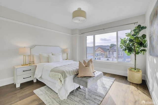 bedroom with dark hardwood / wood-style flooring