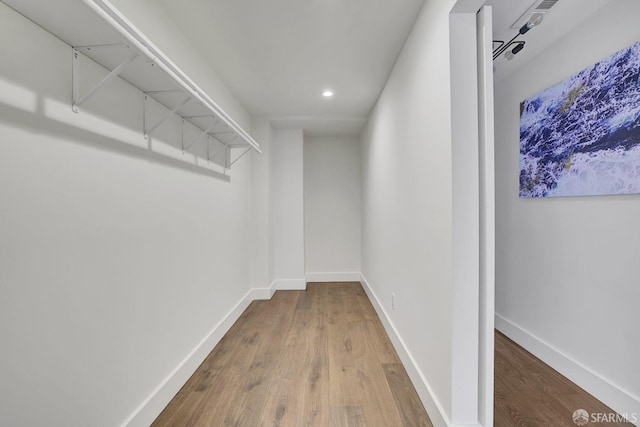 walk in closet featuring hardwood / wood-style floors