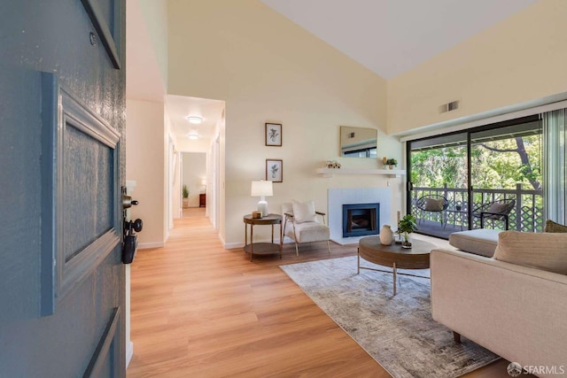 3685 Nutwood Ter Unit 313, Fremont, CA 94536 - living room featuring a towering ceiling, light wood finished floors, a fireplace, and baseboards