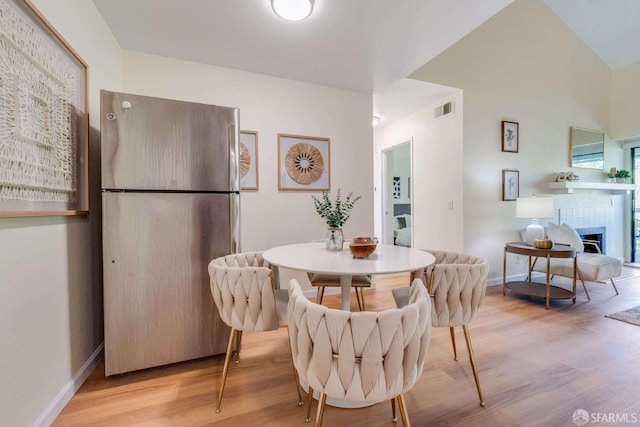 3685 Nutwood Ter Unit 313, Fremont, CA 94536 - dining area with light wood-style flooring, baseboards, and a tile fireplace
