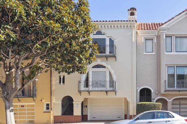 mediterranean / spanish-style home with a garage