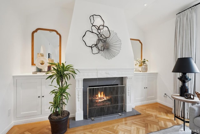 interior space with a premium fireplace and light parquet flooring