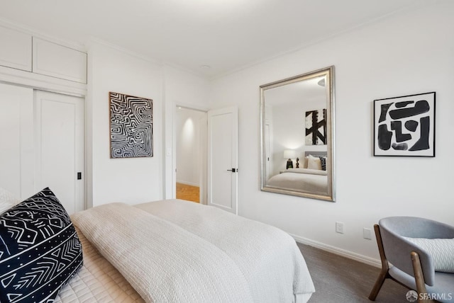 carpeted bedroom with ornamental molding and a closet