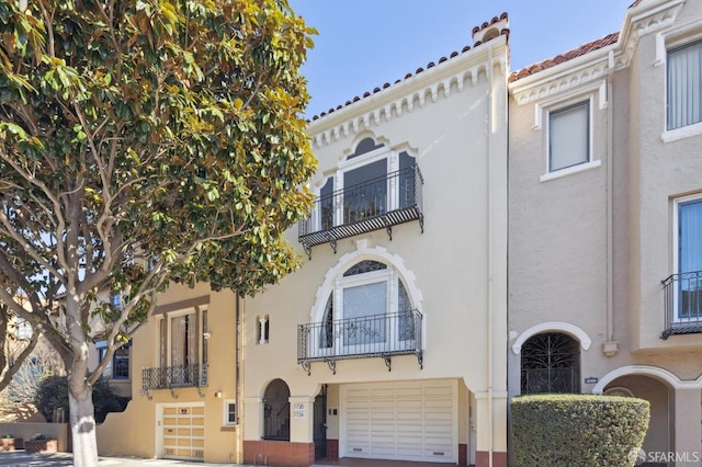 view of front of home featuring a balcony and a garage