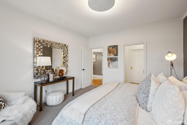 bedroom with crown molding and carpet flooring