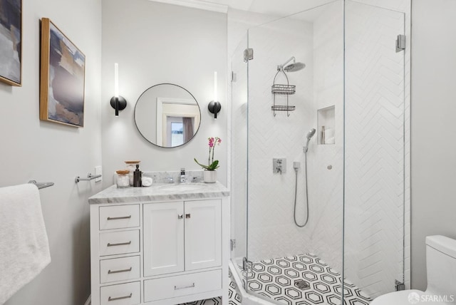 bathroom featuring vanity, toilet, and walk in shower