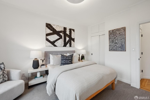 bedroom featuring crown molding and a closet