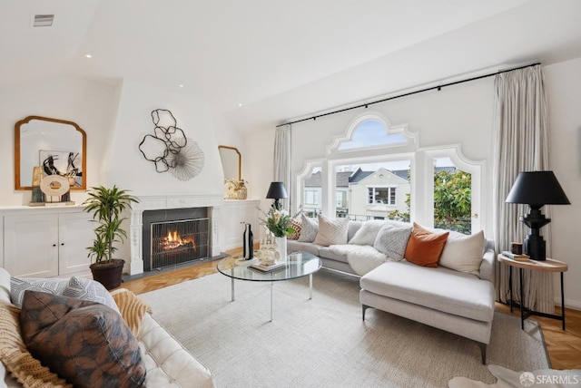 living room featuring a fireplace and light parquet flooring