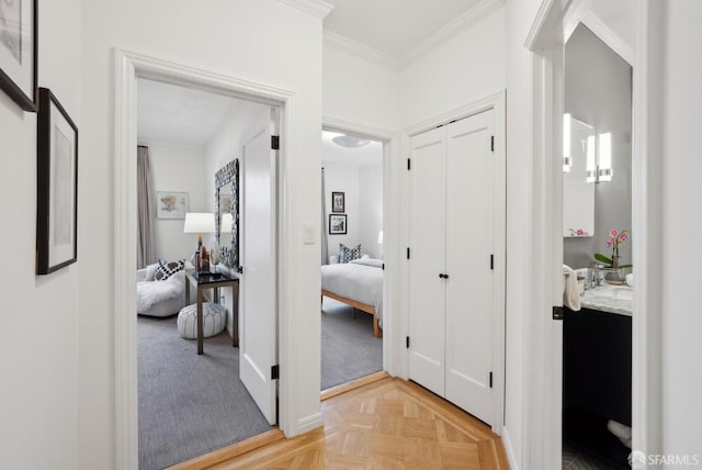 corridor with light parquet flooring and ornamental molding