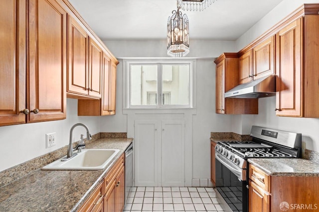 kitchen with a sink, brown cabinetry, under cabinet range hood, and stainless steel appliances