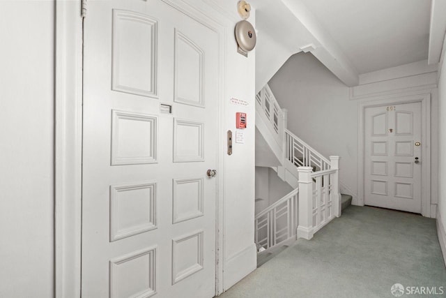 interior space with stairway and carpet