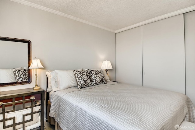 bedroom featuring a textured ceiling, ornamental molding, and a closet