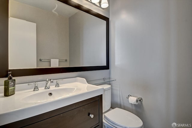 bathroom featuring vanity and toilet