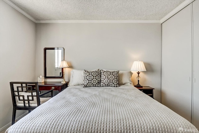 bedroom featuring a closet, a textured ceiling, and crown molding