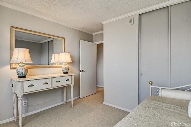 carpeted bedroom featuring ornamental molding, a textured ceiling, and a closet